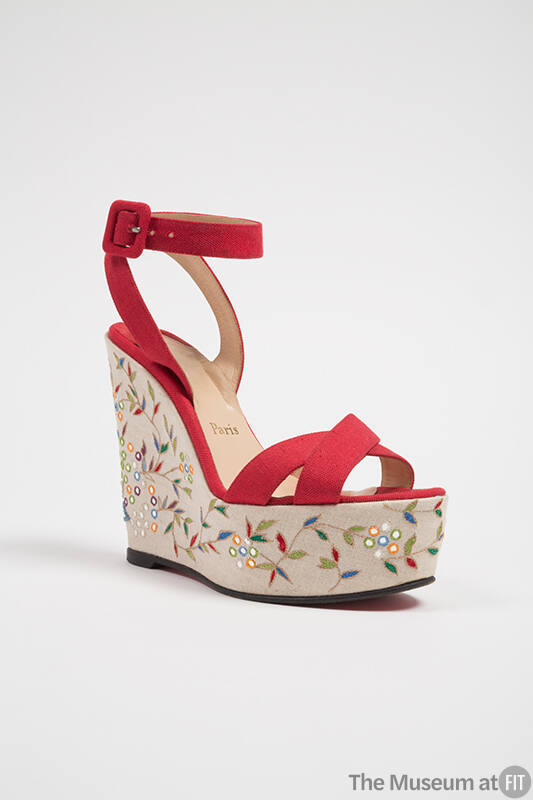 Red platform sandal with wrap ankle strap and beige platform embroidered in multicolor leaf and…