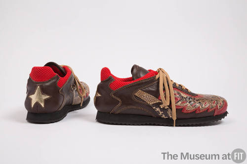 Pair of man’s brown sneakers with snakeskin appliques, red trim on collar and gold star appliqu…