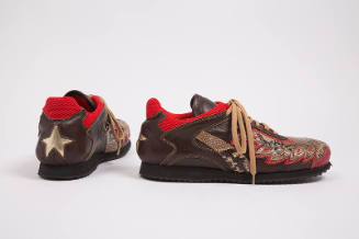 Pair of man’s brown sneakers with snakeskin appliques, red trim on collar and gold star appliqu…