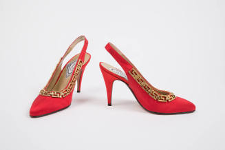 Pair of red high heel sling back pumps with gold Greek key trim around topline 