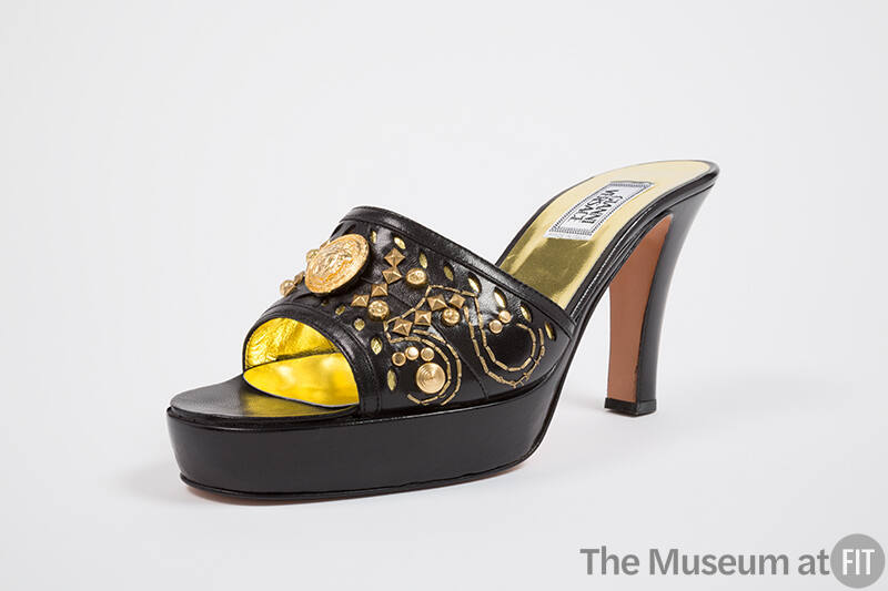 Black platform high heel mule with gold embroidery, studs and medallion on vamp and gold insole…