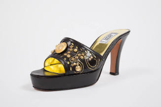 Black platform high heel mule with gold embroidery, studs and medallion on vamp and gold insole…