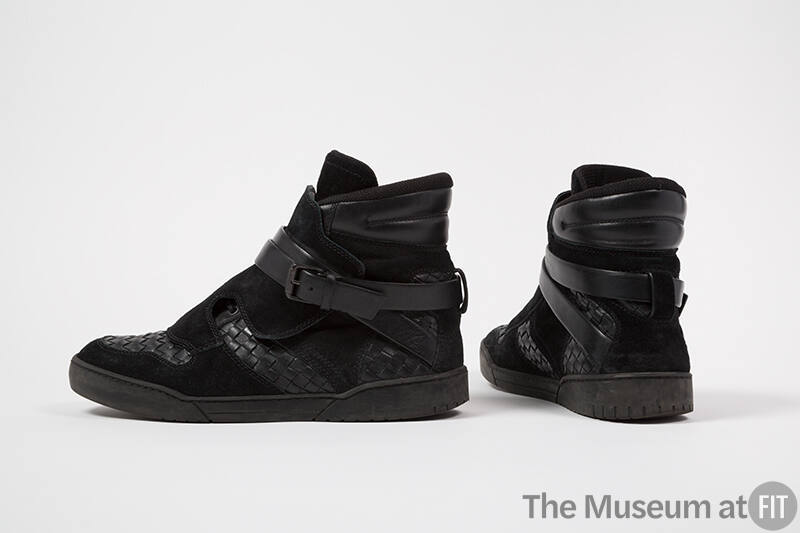 Pair of man’s black suede high top sneakers with woven leather sections throughout and wrap buc…