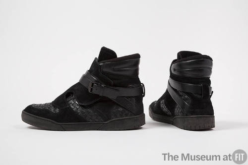 Pair of man’s black suede high top sneakers with woven leather sections throughout and wrap buc…