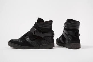 Pair of man’s black suede high top sneakers with woven leather sections throughout and wrap buc…