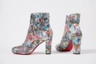 Pair of silver high heel ankle boots with allover black writing and multicolor graffiti-like de…