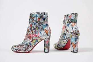 Pair of silver high heel ankle boots with allover black writing and multicolor graffiti-like de…