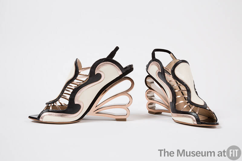 Pair of sling back sandals with off-white, black and pink gold wave design and molded gold scal…