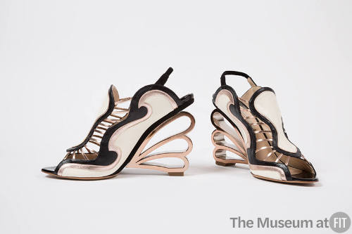 Pair of sling back sandals with off-white, black and pink gold wave design and molded gold scal…