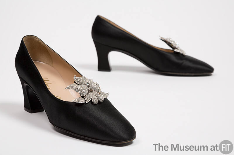 Black satin low heel pumps with rhinestone flower at front 