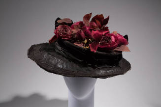 Black hat with wide brim and dark red roses and leaves on flat oversize crown