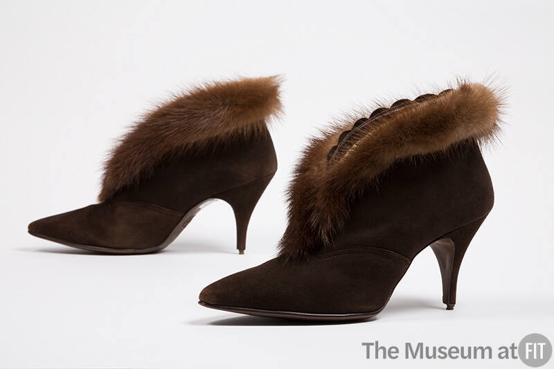 Pair of brown suede ankle boots with pointed toe, stiletto heel and brown mink fur trim around …