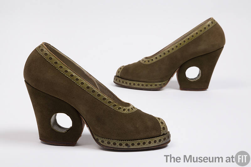 Pair of olive green suede pumps with perforated green leather trim around topline, open toe and…