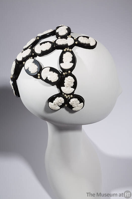 Head band hat with oval black discs with white cameos 