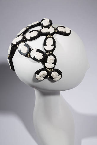 Head band hat with oval black discs with white cameos 