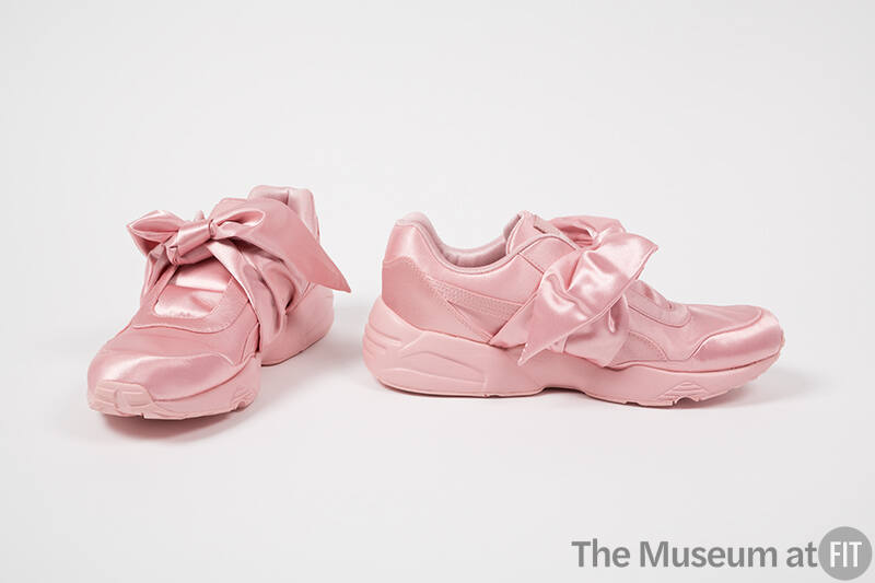 Pair of entirely pink lace-less athletic sneakers with large bow tie closure