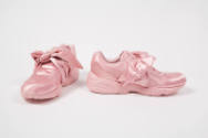 Pair of entirely pink lace-less athletic sneakers with large bow tie closure
