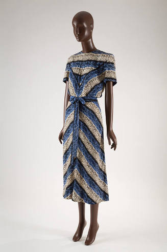 Calf length dress with short sleeves, printed with white, black and blue abstract stripe patter…