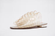 Low heeled mule sandal made of looped clear vinyl strips