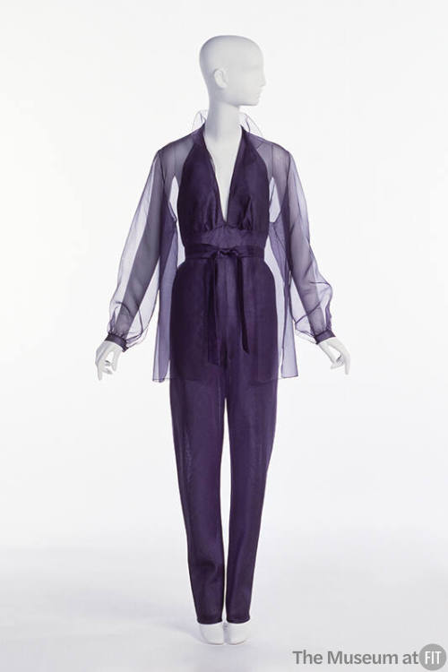 Purple organza jumpsuit with halter neck; matching sheer overblouse.
