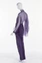 Back view of purple organza jumpsuit with halter neck; matching sheer overblouse.
