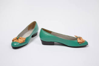 Green leather pumps with orange satin ribbon bow and low heel