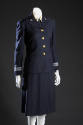 3/4 view of uniform suit with dim lighting and dark background and without hat