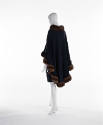 Back view of green poncho with brown fur collar and hem  trim