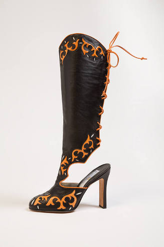 Black western style boot with orange, scroll-like lizard inserts, orange back lacing, scallop c…