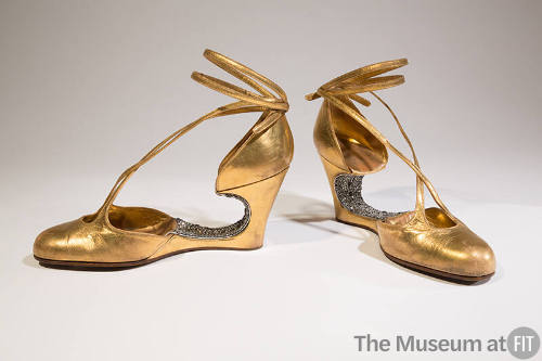 Gold metallic evening shoes with rhinestone encrusted voided arch, wedge, and ankle tie straps