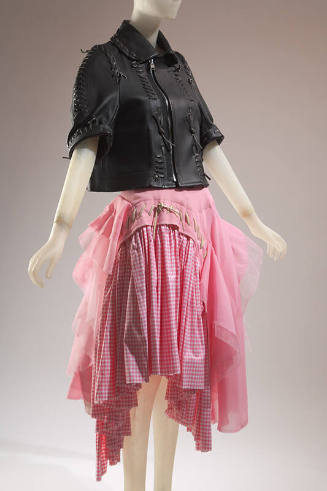Biker/motorcyle inspired black leather jacket; ballerina inspired asymmetrical pink skirt with …