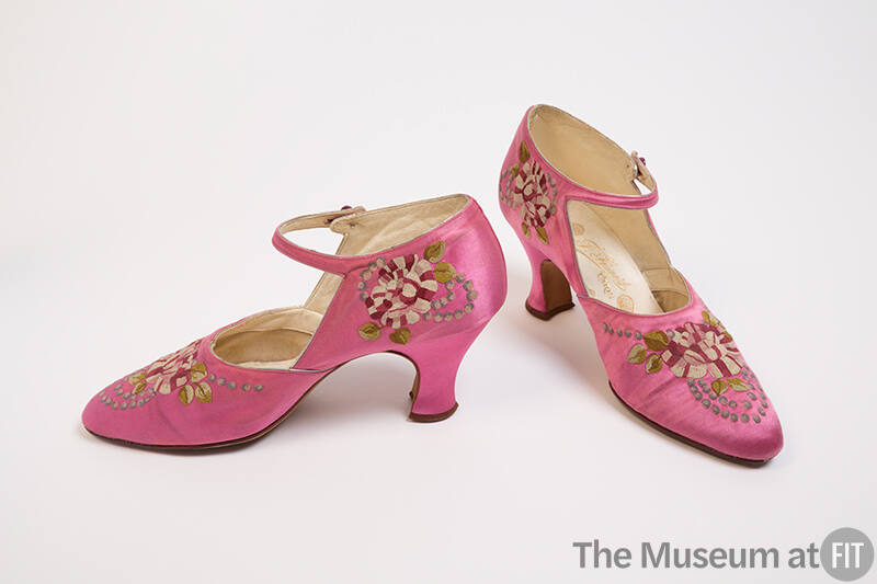 Pair of pink ankle strap pumps embroidered with pink, white, green and blue flower motif and Lo…