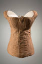 Front view of light brown underbodice and stays showing off-white top stitching and floral embr…