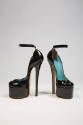 Black patent leather platform ankle strap shoe with high spike heel