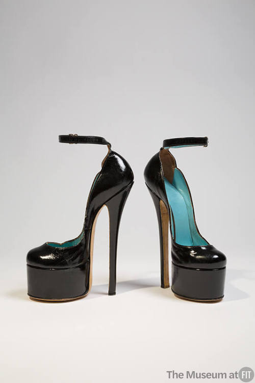 Black patent leather platform ankle strap shoe with high spike heel