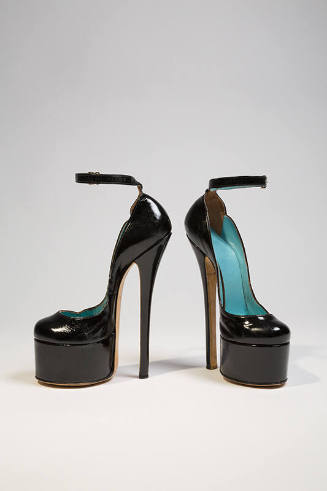 Black patent leather platform ankle strap shoe with high spike heel