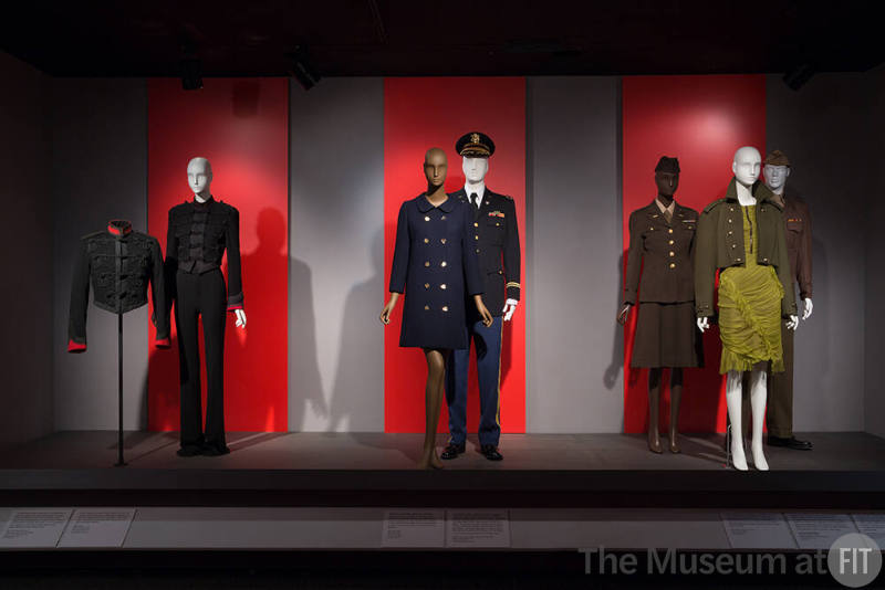 Installation image of platform with six dressed mannequins in military uniforms and military un…