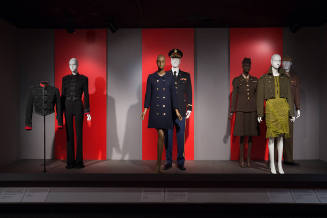 Installation image of platform with six dressed mannequins in military uniforms and military un…