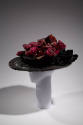 Alternate view of black wide brimmed hat showing large satin ribbon around crown and tied in bo…