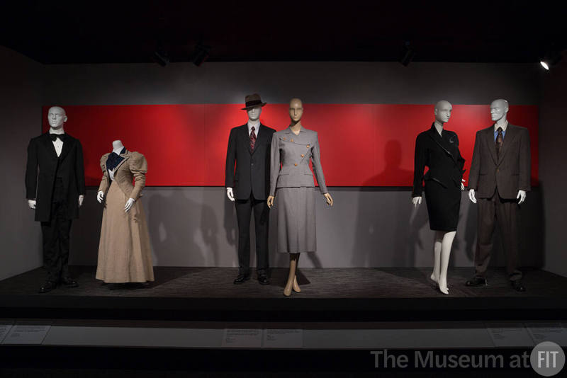 Power_Mode_18 Left to right P90.2.4 (suit), P84.26.1 (skirt suit),  74.69.57 (hat), 2012.37.1 (suit), 2010.1.52 (skirt suit), 2016.47.2 (skirt suit), 85.58.7 (suit)
