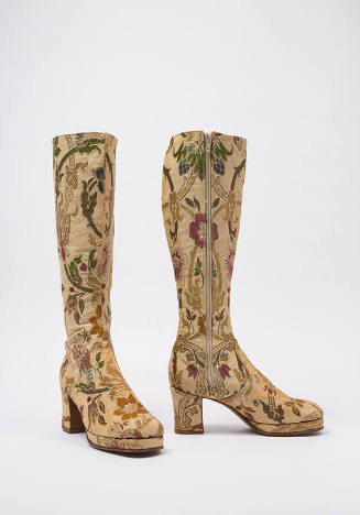 Knee high beige boots with floral and bird motifs in olive, green, gold, and red