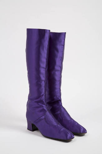 Pair of purple knee high boots with stitched spiral design on vamp