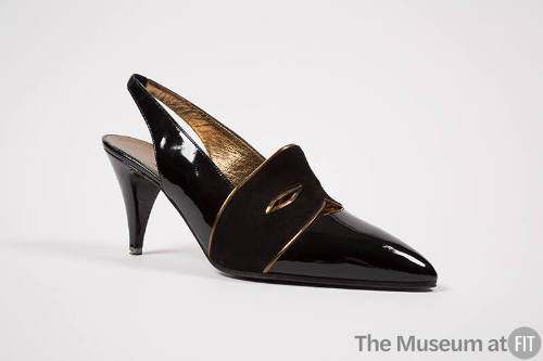 Black high heel sling back shoes with black suede mask acroos front with gold trim 