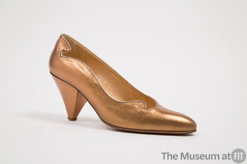 Bronze metallic pump with scrolled edge and conical shaped heel 