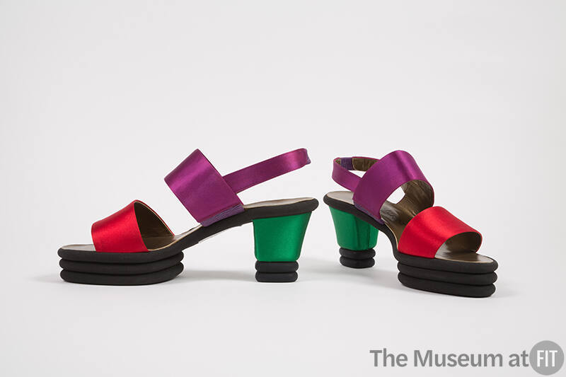 Pair of sling back sandals with wide red toe strap, purple instep strap, green block heel and b…