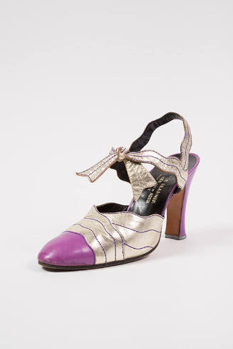 Gold metallic shoe with light purple toe cap and high Louis heel, ankle strap and bow at instep