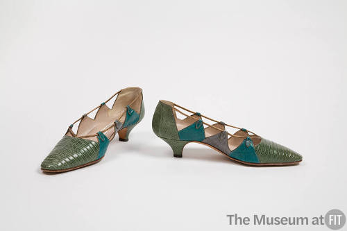 Pair of green low heeled lizard pumps with triangular pieces on sides in turquoise blue and gre…
