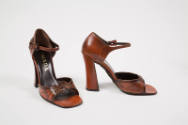 Pair of rust brown sandals with flower applique at vamp, ankle strap, very high block heel and …
