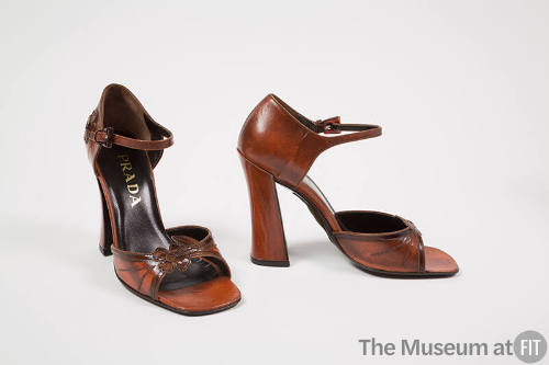 Pair of rust brown sandals with flower applique at vamp, ankle strap, very high block heel and …