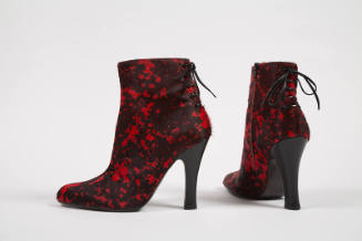 Pair of black calf hair ankle boots with red splatter design, mock lacing up center back and hi…